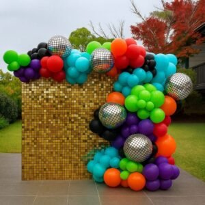 Gold shimmer wall backdrop with balloon garland for party hire in Sydney