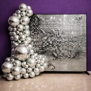 Silver shimmer wall backdrop with silver balloon garland for party hire