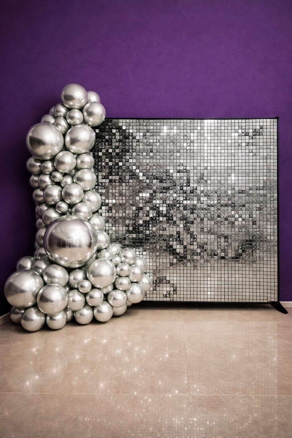 Silver shimmer wall backdrop with silver balloon garland for party hire